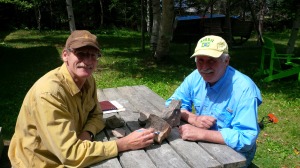 Mark Fields with Wayne Carroll examining molybenite bearing boulder from Pabineau Property.